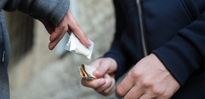 close up of addict buying dose from drug dealer