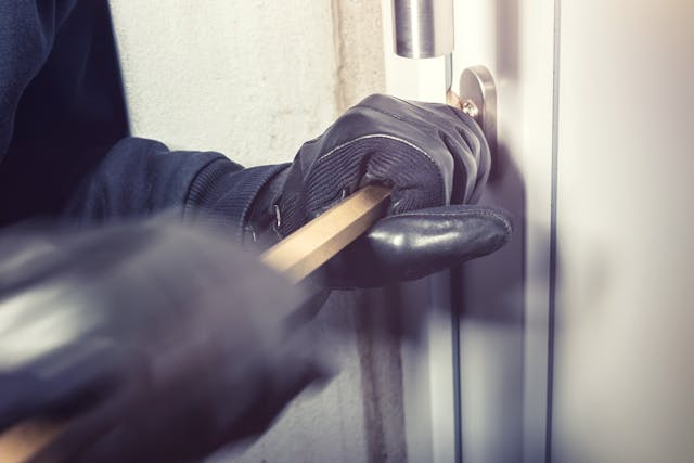 person breaking into a door