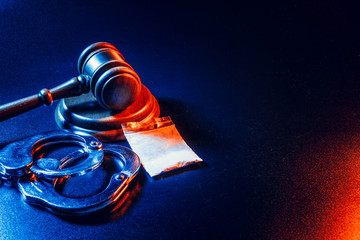 gavel and drug bag and handcuffs