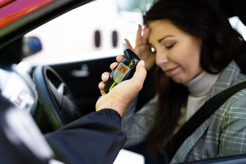 woman with cop and breathalyzer of .76