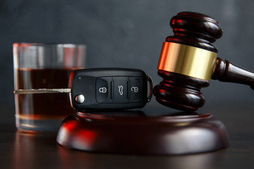 gavel with car keys and whiskey drink