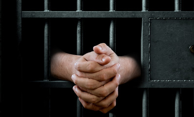 hands in jail cell