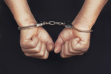 person in handcuffs arrested