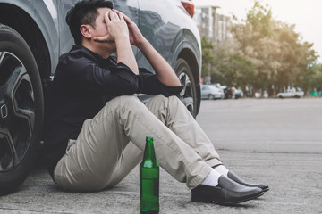 boy with beer outside of car