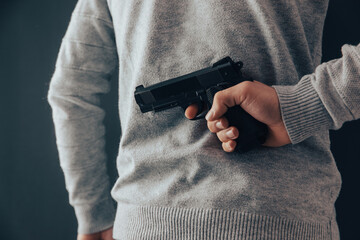 concealed gun behind back