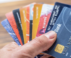 person holding a bunch of credit cards||