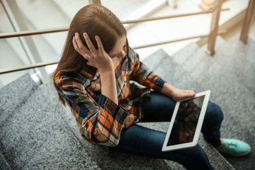 stressed woman on tablet