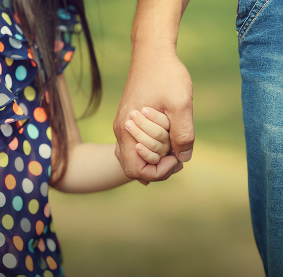 person holding a child's hand
