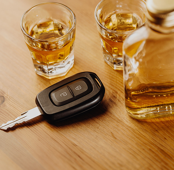 car keys next to glasses of whiskey