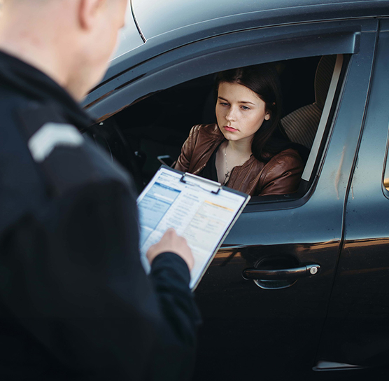 police officer writing a woman a ticket
